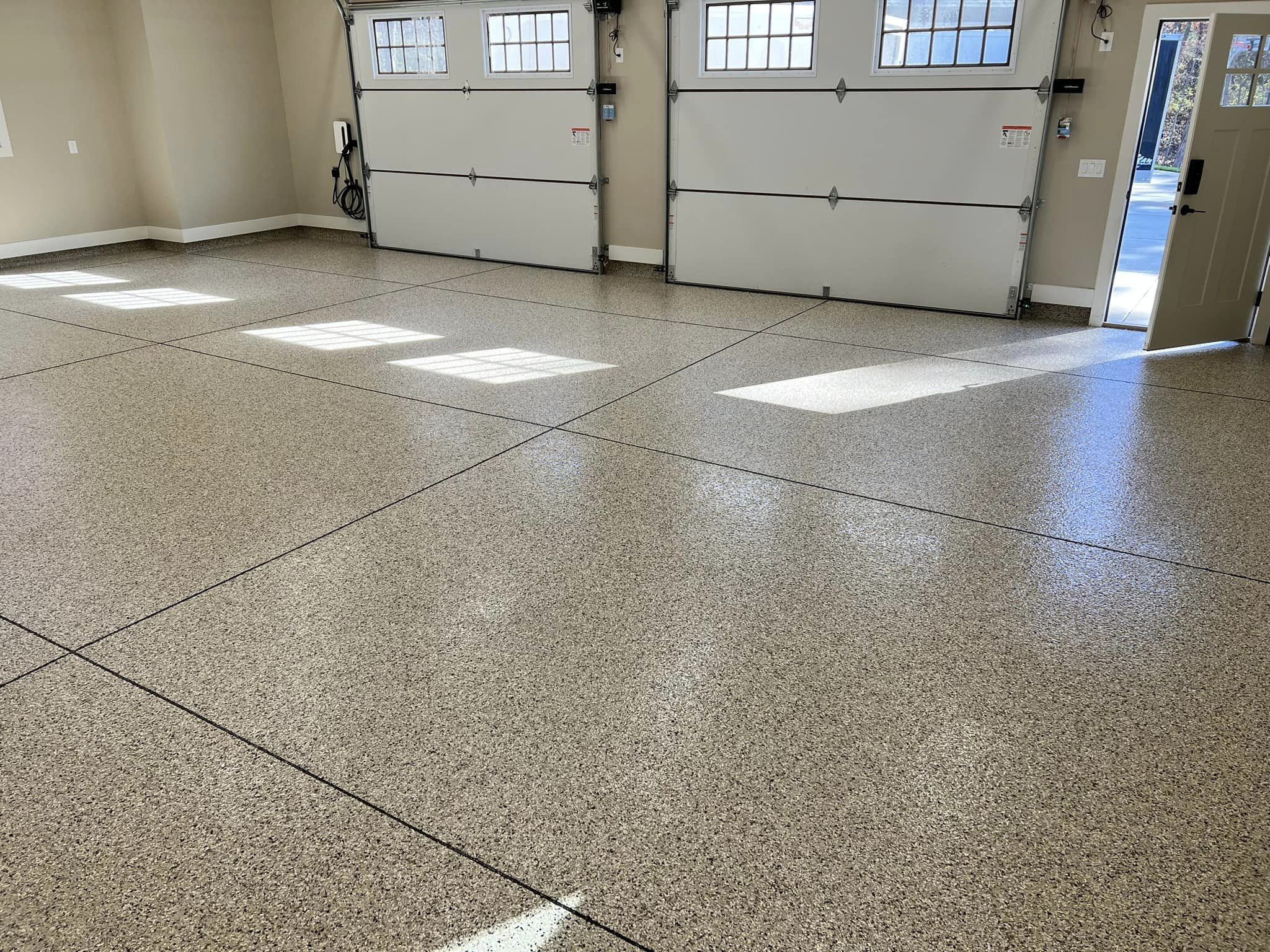 Epoxy flake flooring in garage lines cut in 